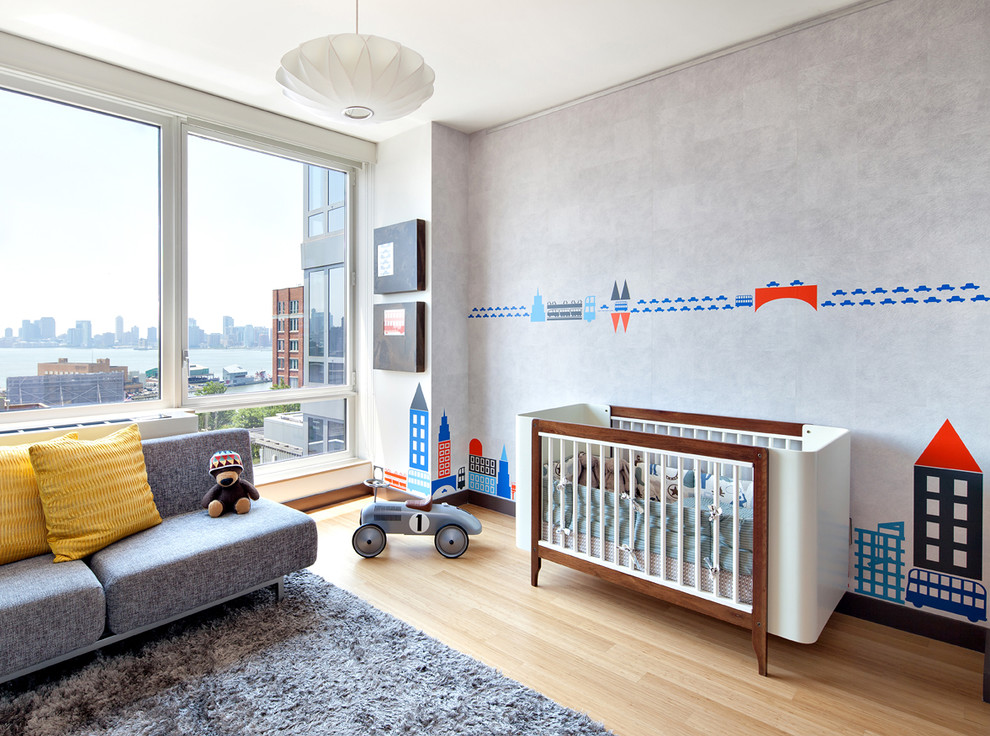 Design ideas for a mid-sized contemporary kids' room for boys in New York with grey walls, medium hardwood floors and beige floor.