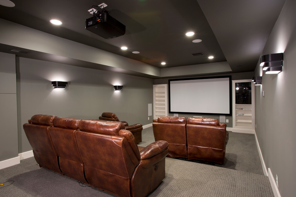 Inspiration for a mid-sized traditional enclosed home theatre in DC Metro with grey walls and carpet.