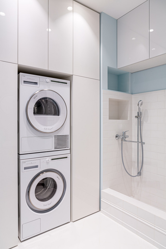 This is an example of a contemporary laundry room in Other with a stacked washer and dryer.