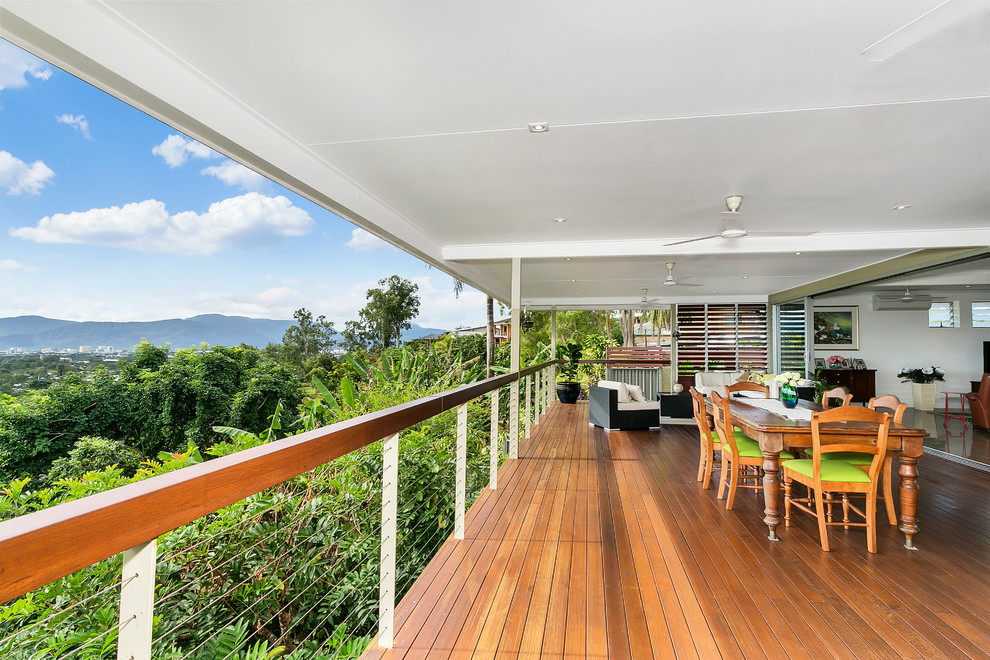 Mid-sized contemporary backyard deck in Cairns with an outdoor kitchen and a roof extension.