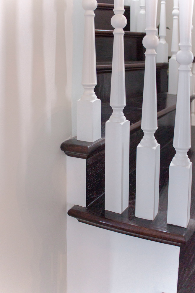 This is an example of a large transitional wood spiral staircase in DC Metro with wood risers and wood railing.