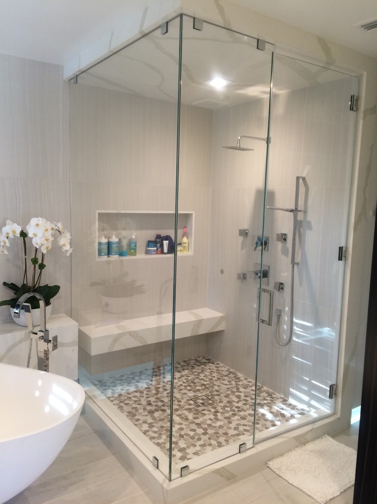 Large transitional master bathroom in Los Angeles with a corner shower, multi-coloured tile, pebble tile, grey walls, vinyl floors, a vessel sink and a freestanding tub.
