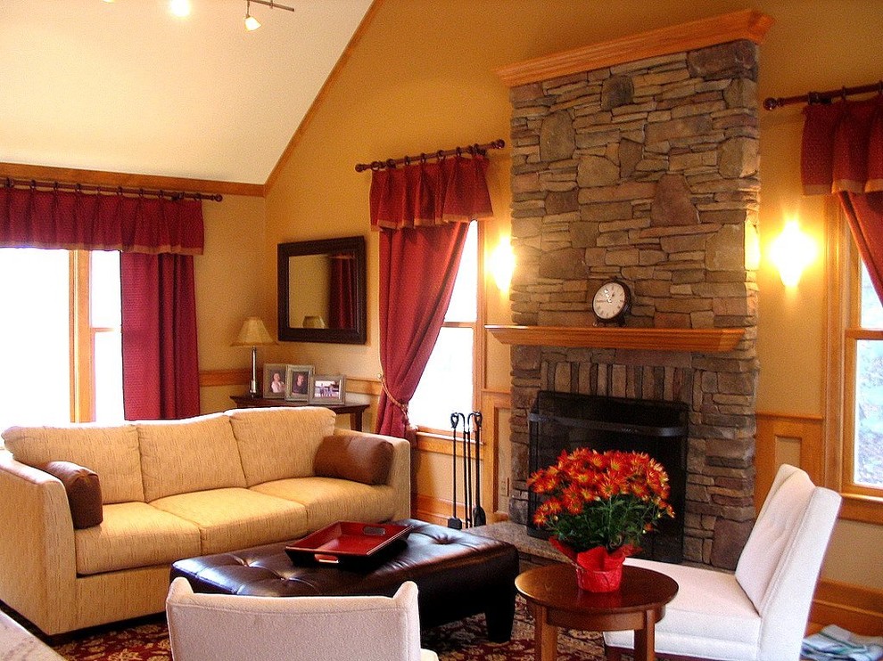 Photo of a mid-sized traditional open concept family room in Boston with beige walls, medium hardwood floors, a standard fireplace, a stone fireplace surround and a wall-mounted tv.