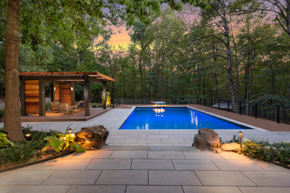 Design ideas for a contemporary rectangular pool in DC Metro with tile.