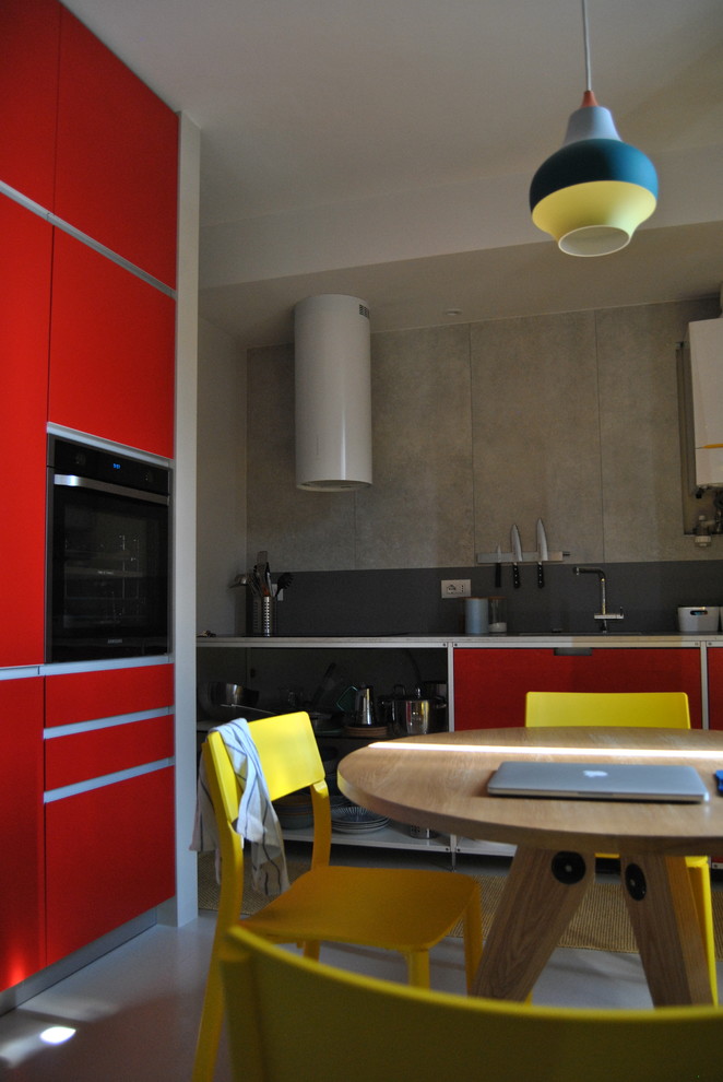 This is an example of a small contemporary open plan dining in Milan with white walls.