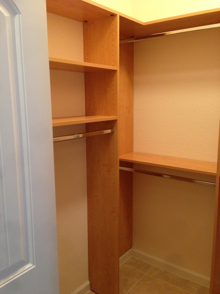 Mid-sized traditional men's walk-in wardrobe in Orlando with open cabinets, medium wood cabinets and ceramic floors.