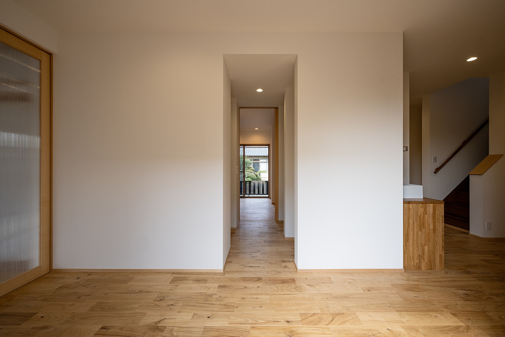 Aménagement d'un grand couloir scandinave avec un mur blanc, un sol en bois brun, un sol beige, un plafond en papier peint et du papier peint.