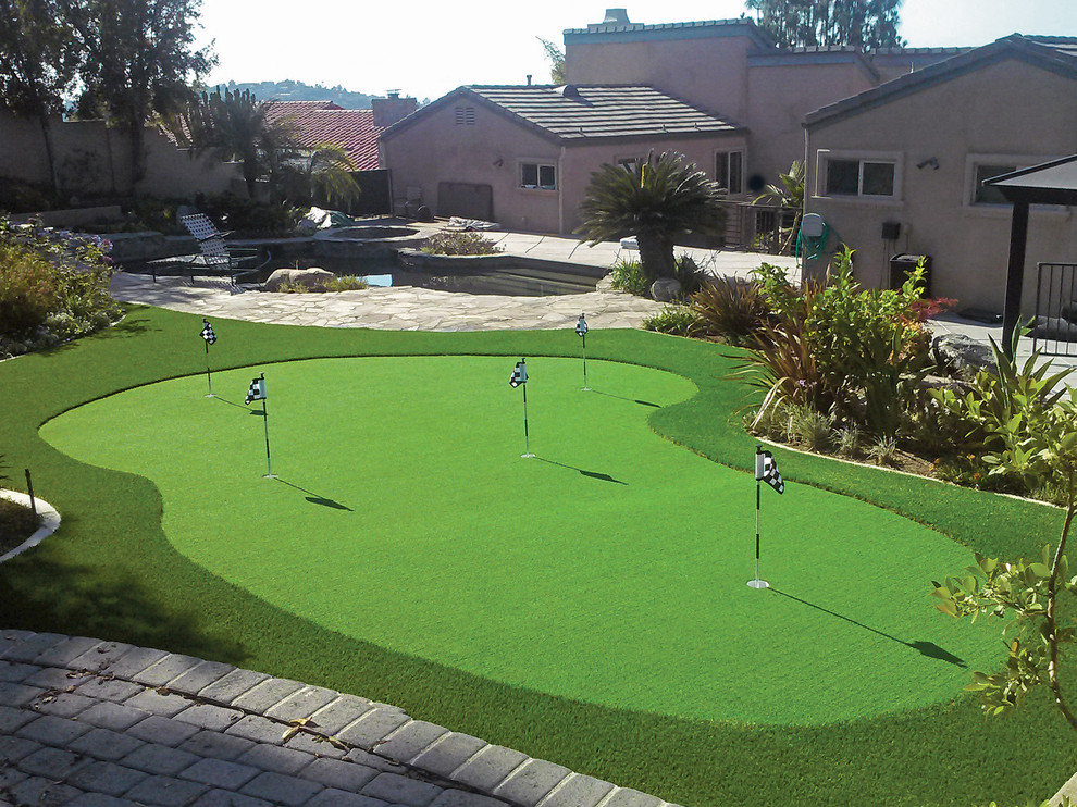 Design ideas for a large mediterranean backyard full sun outdoor sport court in Orange County with with outdoor playset and natural stone pavers.