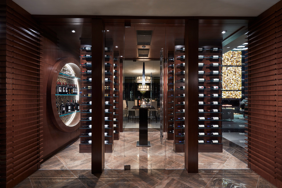 Contemporary wine cellar in Miami with display racks and beige floor.