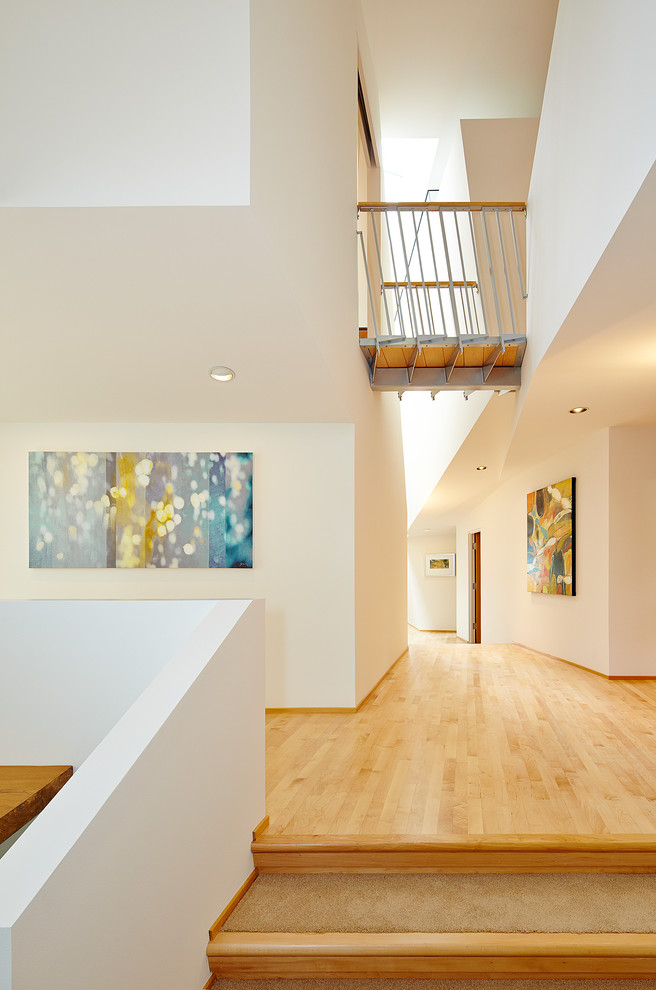 This is an example of a contemporary entryway in Seattle with white walls.