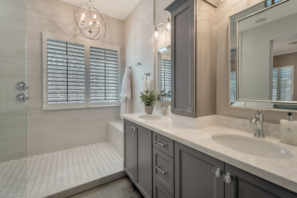 Doorless shower - mid-sized transitional master white tile and porcelain tile wood-look tile floor, multicolored floor and double-sink doorless shower idea in Phoenix with shaker cabinets, gray cabinets, gray walls, an undermount sink, granite countertops, white countertops and a niche