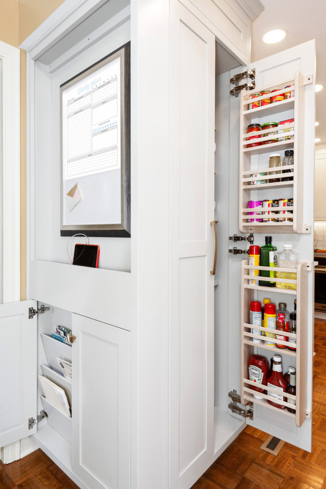 This is an example of a small eclectic l-shaped kitchen pantry in Other with a farmhouse sink, beaded inset cabinets, white cabinets, quartz benchtops, blue splashback, terra-cotta splashback, stainless steel appliances, medium hardwood floors, a peninsula, brown floor and grey benchtop.