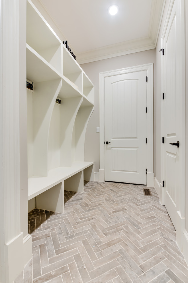 Mid-sized transitional mudroom in Other with ceramic floors, beige walls and beige floor.