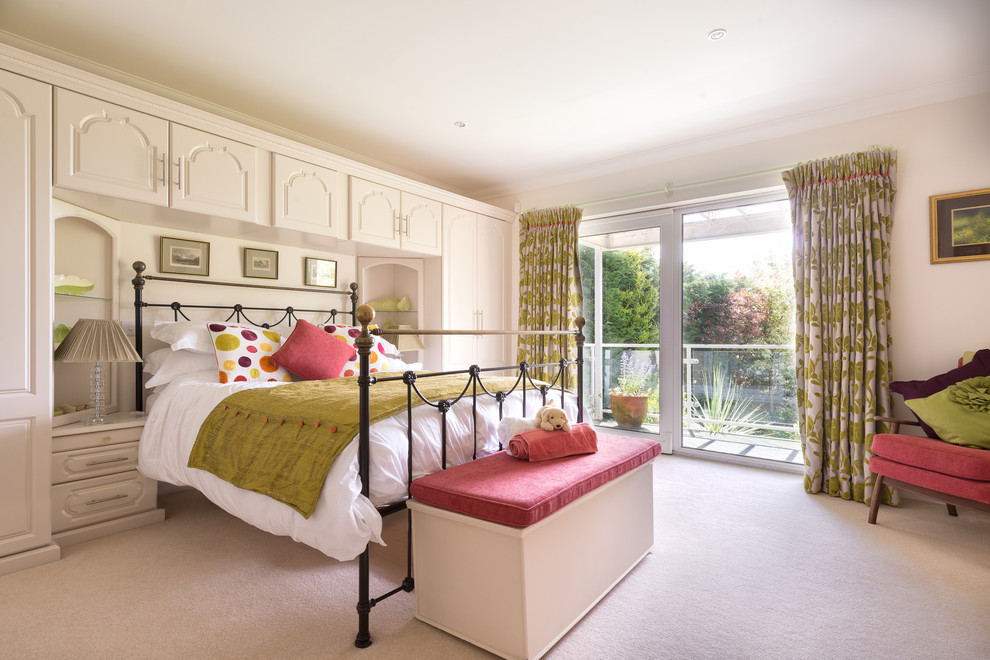 Design ideas for a traditional guest bedroom in Devon with beige walls, carpet and pink floor.