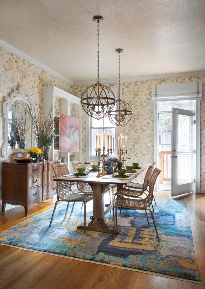 Inspiration for a mid-sized transitional separate dining room in Boston with multi-coloured walls, medium hardwood floors, brown floor and a standard fireplace.