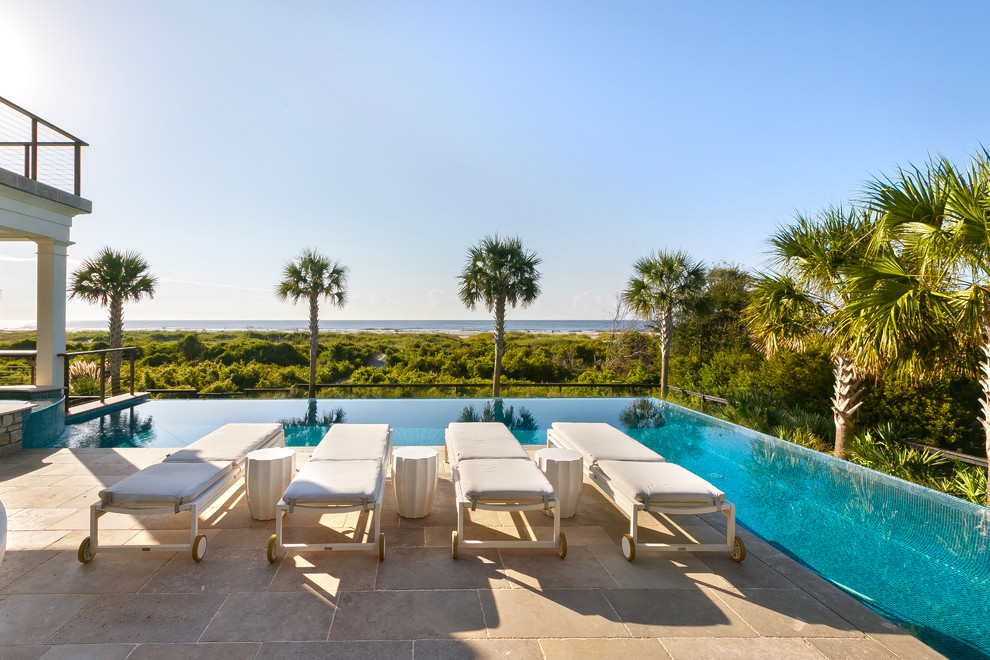Design ideas for a beach style backyard l-shaped infinity pool in Charleston with a hot tub and tile.