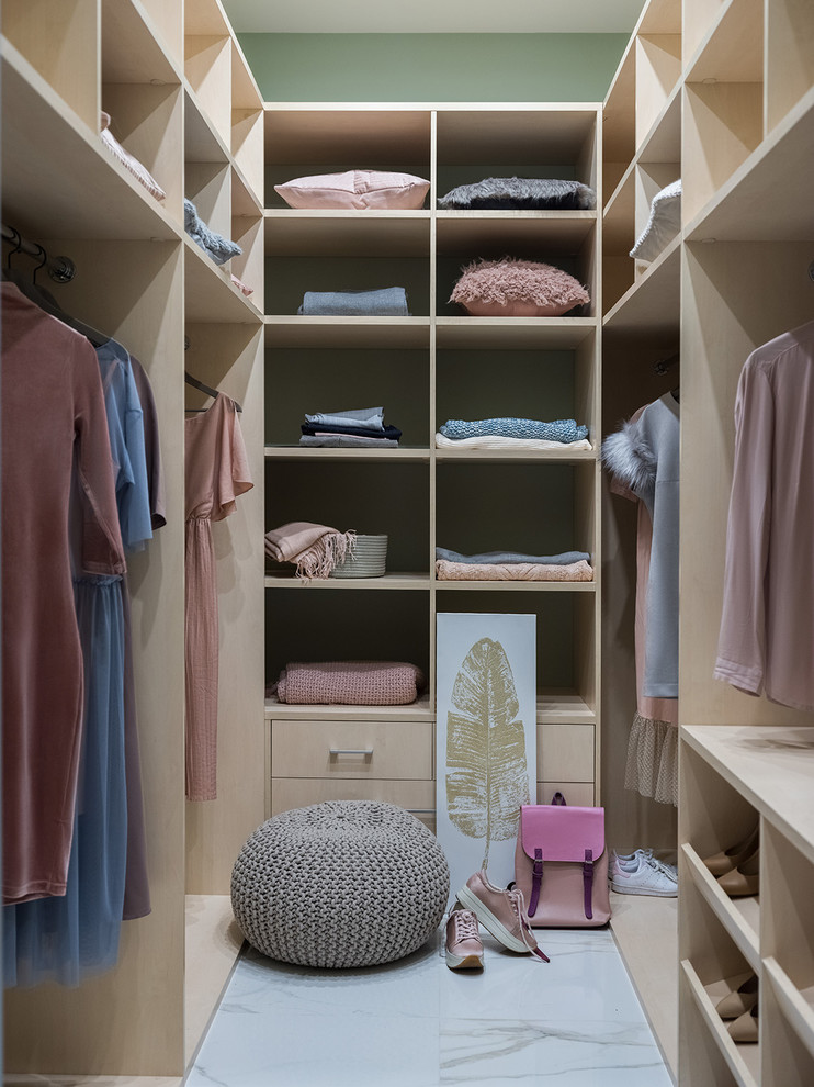 Design ideas for a contemporary gender-neutral walk-in wardrobe in Moscow with flat-panel cabinets, beige cabinets and grey floor.