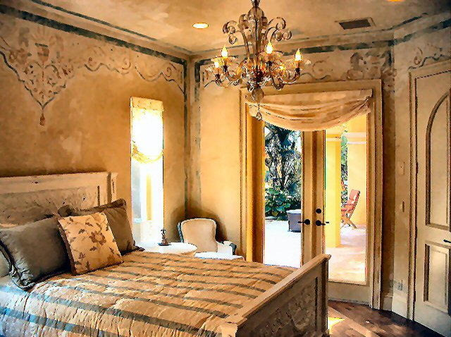 This is an example of a mid-sized mediterranean guest bedroom in Tampa with medium hardwood floors, brown walls, no fireplace and brown floor.