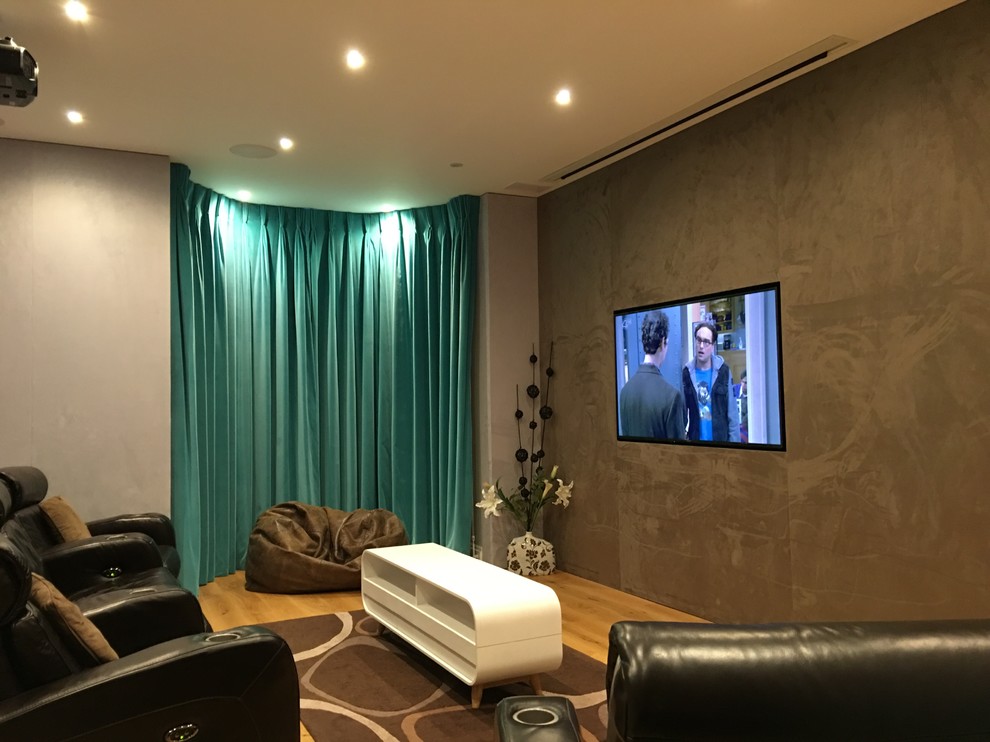 Inspiration for a medium sized modern enclosed home cinema in London with brown walls and a projector screen.
