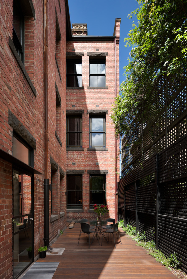 Design ideas for a medium sized and red contemporary brick detached house in Melbourne with three floors.