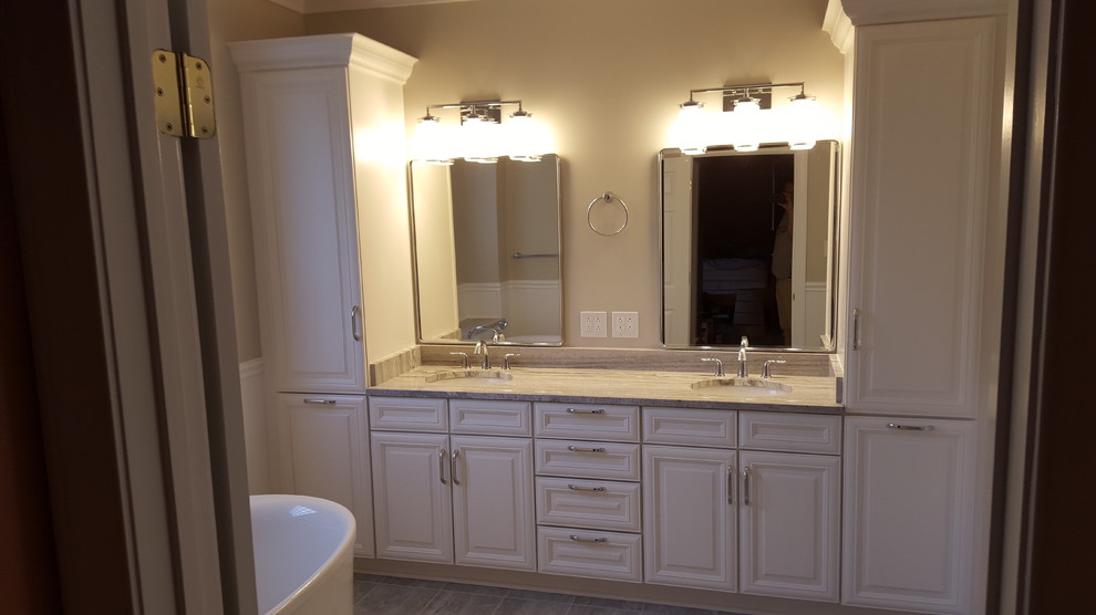 Mid-sized contemporary master bathroom in Richmond with raised-panel cabinets, white cabinets, a freestanding tub, a two-piece toilet, gray tile, porcelain tile, grey walls, porcelain floors, an undermount sink and granite benchtops.