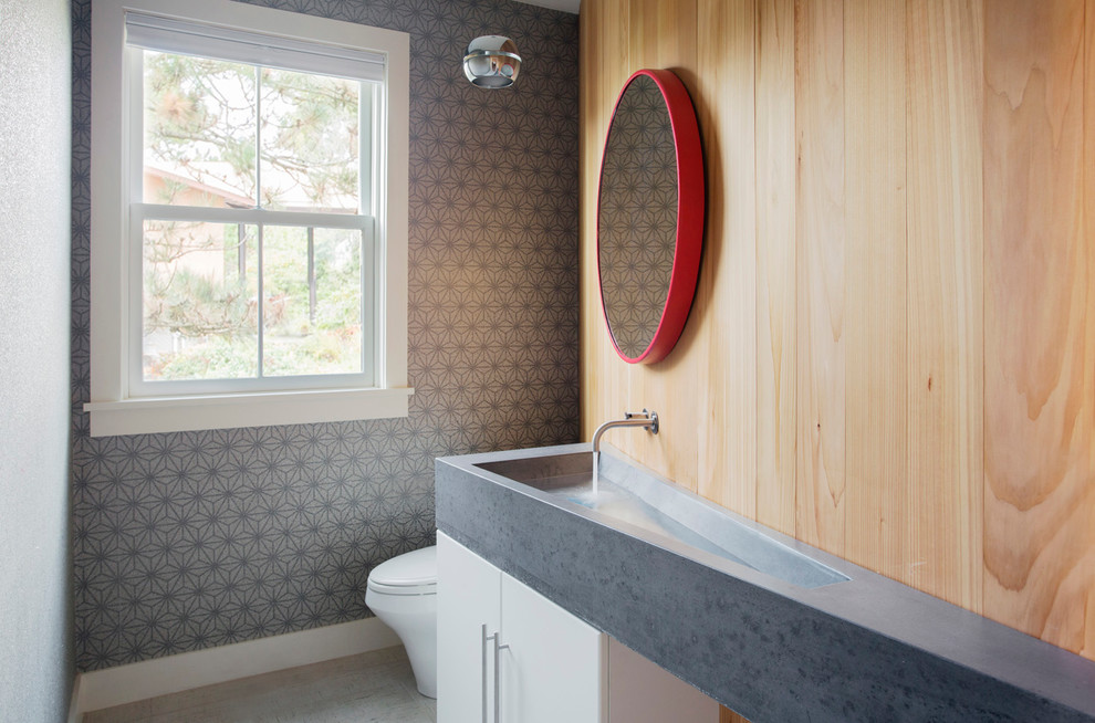 This is an example of a contemporary powder room in Boston with an integrated sink and grey walls.