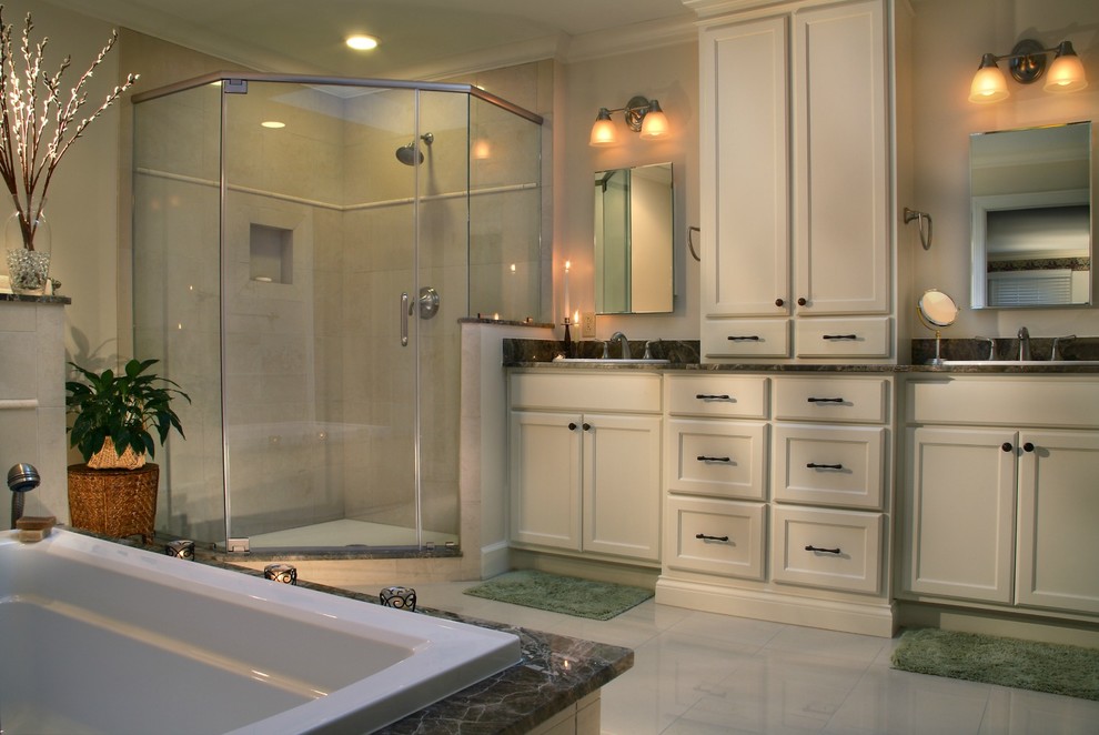 Inspiration for a large transitional master porcelain tile drop-in bathtub remodel with flat-panel cabinets, white cabinets, marble countertops, black backsplash, stone tile backsplash, beige walls and a drop-in sink