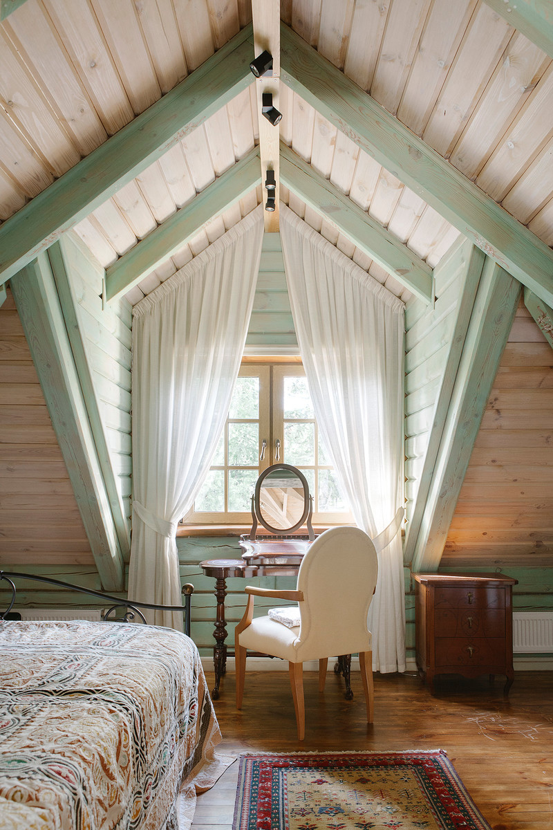 Inspiration for a country bedroom in Moscow with beige walls and brown floor.