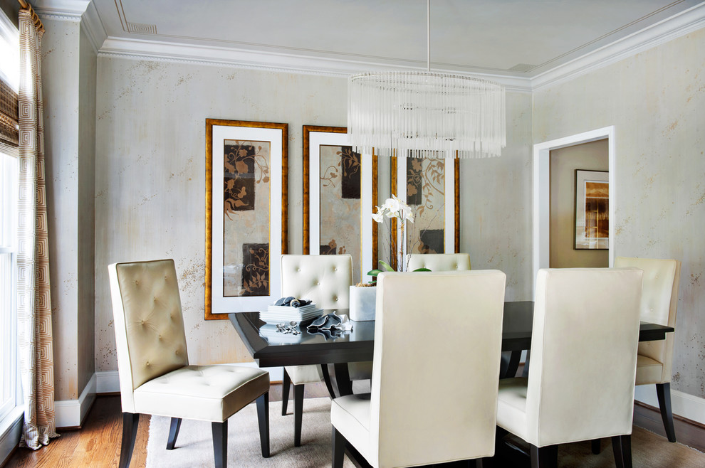 Example of a classic medium tone wood floor and brown floor enclosed dining room design with no fireplace and beige walls