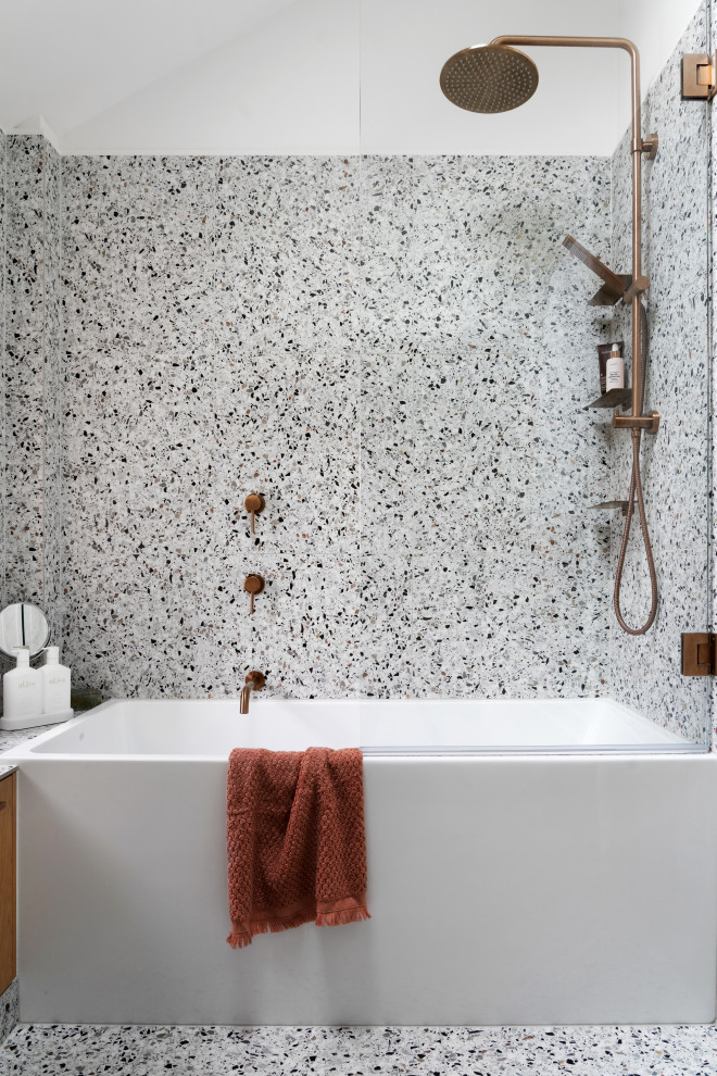 Design ideas for a small contemporary master bathroom in Melbourne with shaker cabinets, medium wood cabinets, a drop-in tub, a shower/bathtub combo, a one-piece toilet, multi-coloured tile, porcelain tile, multi-coloured walls, terrazzo floors, a vessel sink, engineered quartz benchtops, multi-coloured floor, a hinged shower door, white benchtops, a single vanity, a built-in vanity, vaulted and planked wall panelling.
