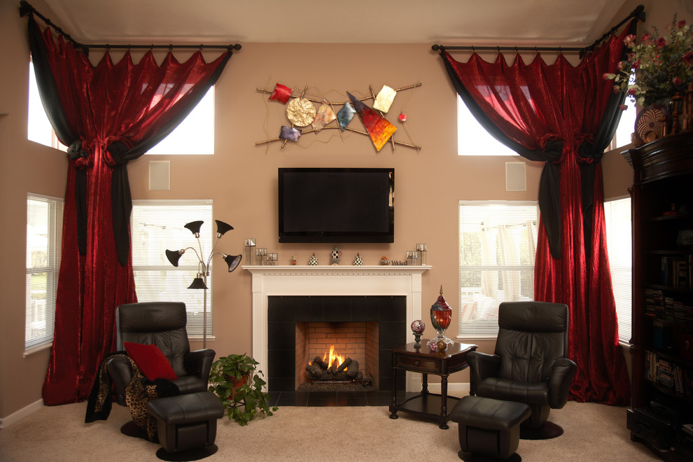 This is an example of a mid-sized traditional open concept living room in Columbus with beige walls, carpet, a standard fireplace, a tile fireplace surround and a wall-mounted tv.