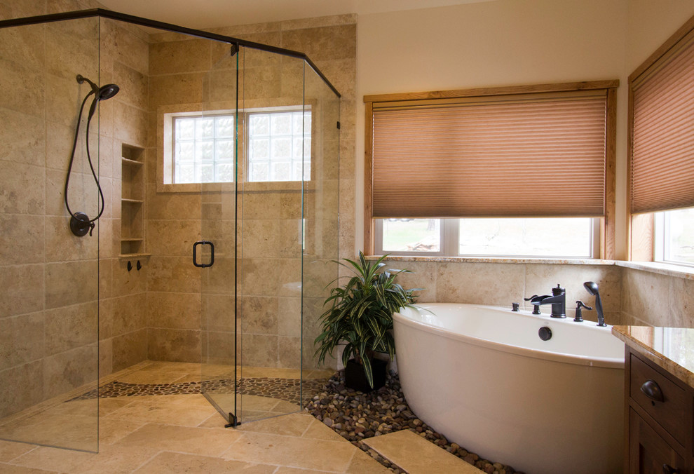 Design ideas for a large transitional master bathroom in Albuquerque with a vessel sink, recessed-panel cabinets, granite benchtops, a freestanding tub, a corner shower, a two-piece toilet, beige tile, stone tile, beige walls and travertine floors.