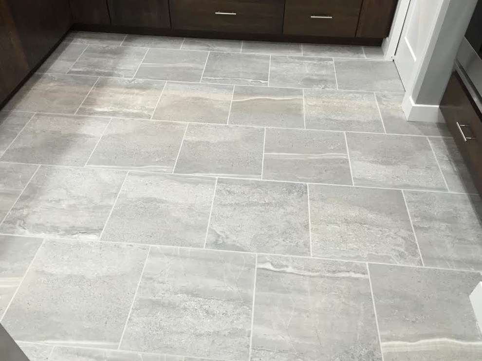 Mid-sized transitional l-shaped porcelain tile and gray floor eat-in kitchen photo in Cedar Rapids with a double-bowl sink, flat-panel cabinets, dark wood cabinets, granite countertops, stainless steel appliances and a peninsula