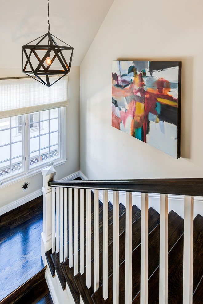Photo of a transitional wood u-shaped staircase in San Francisco with wood risers.