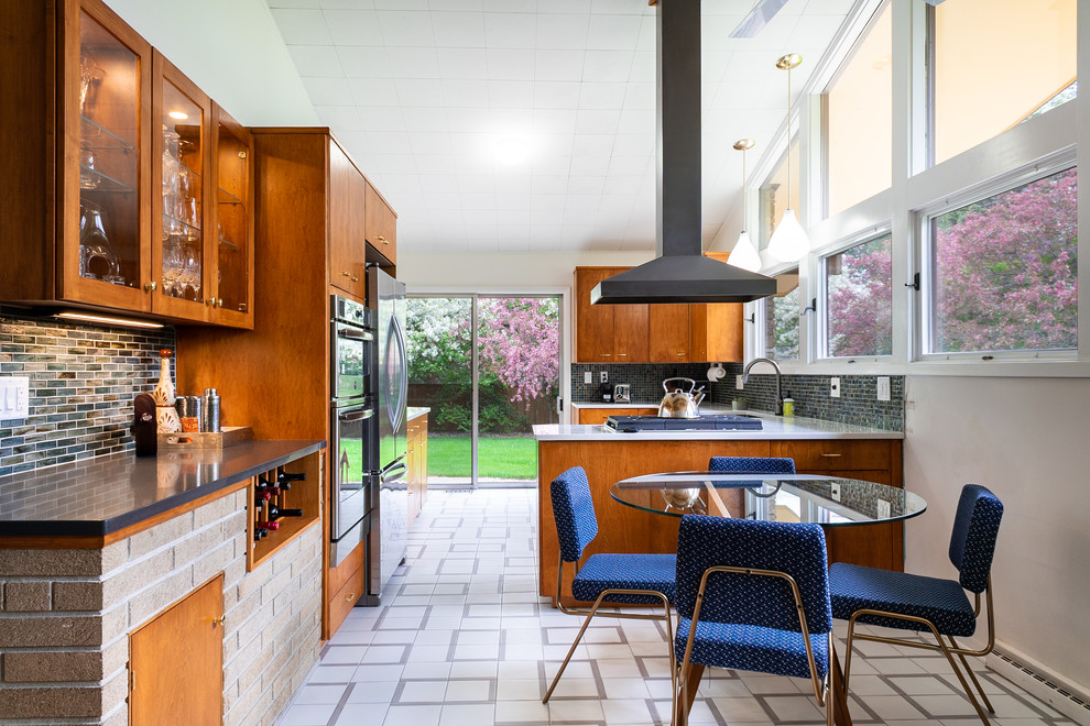 Design ideas for a midcentury u-shaped eat-in kitchen in Other with an undermount sink, flat-panel cabinets, medium wood cabinets, blue splashback, mosaic tile splashback, stainless steel appliances, a peninsula, white floor and white benchtop.