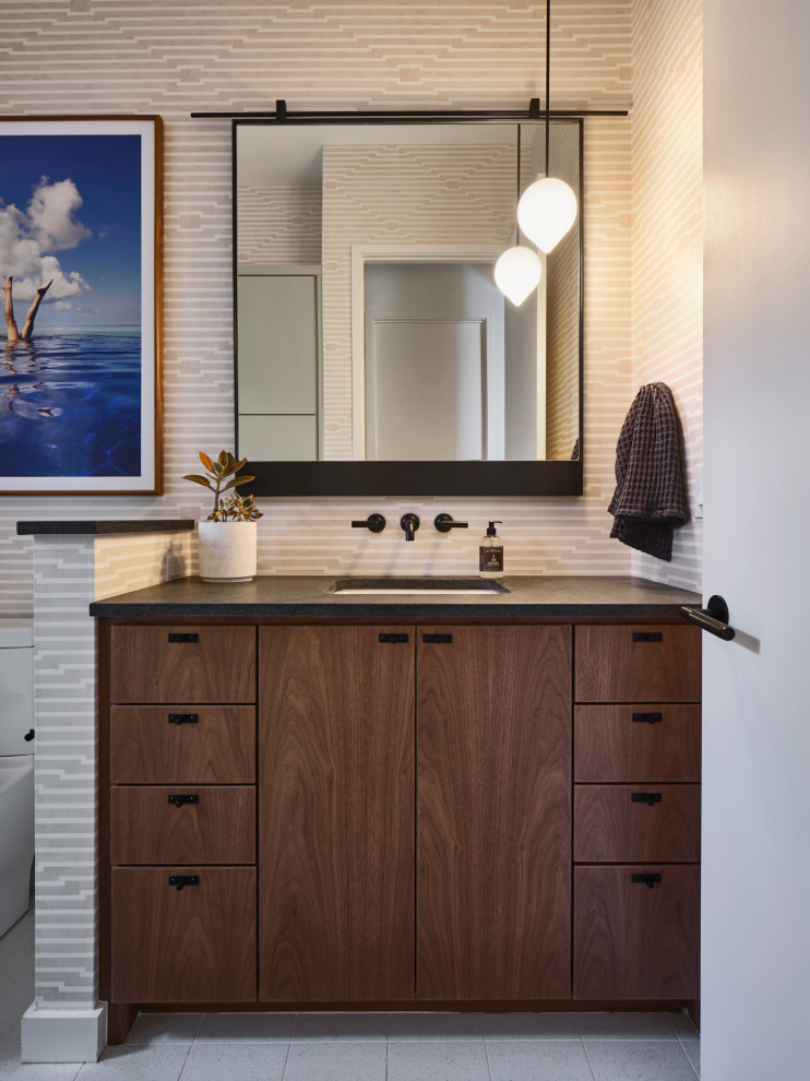 Photo of a contemporary bathroom in Austin with dark wood cabinets, beige walls, an undermount sink, grey floor, black benchtops, a single vanity, a built-in vanity and wallpaper.