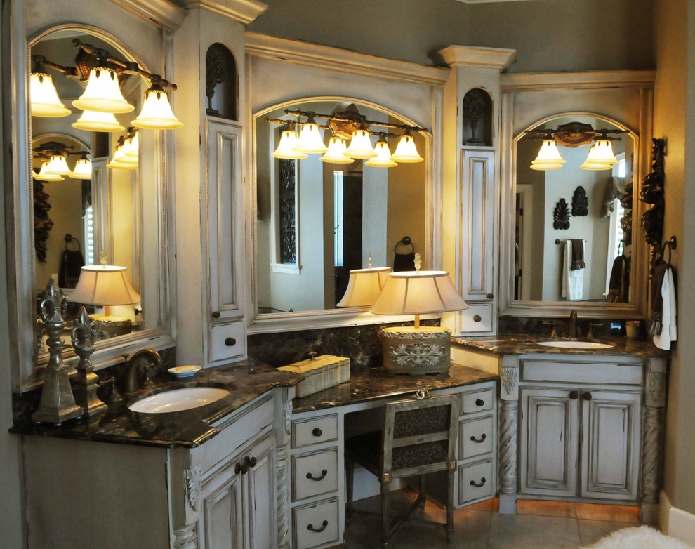 This is an example of a mediterranean master bathroom in Other with recessed-panel cabinets, beige cabinets, porcelain floors, an undermount sink and beige floor.