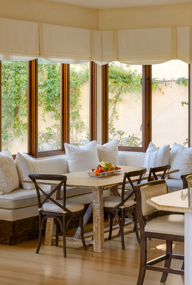 Kitchen/dining room combo - mid-sized mediterranean kitchen/dining room combo idea in Santa Barbara with beaded inset cabinets, beige cabinets and an island