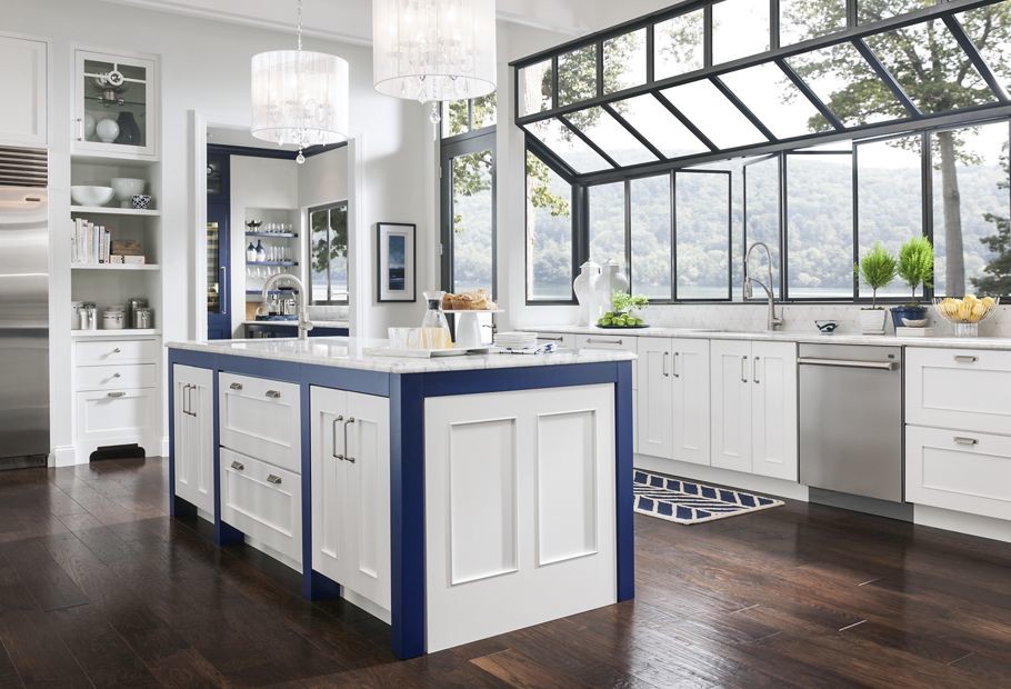 Design ideas for a large traditional u-shaped separate kitchen in New Orleans with an undermount sink, recessed-panel cabinets, white cabinets, quartzite benchtops, white splashback, ceramic splashback, stainless steel appliances, dark hardwood floors and with island.