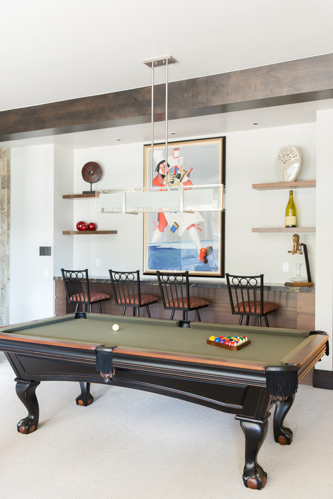 This is an example of a transitional family room in Salt Lake City with a game room, white walls, a standard fireplace, a built-in media wall and beige floor.
