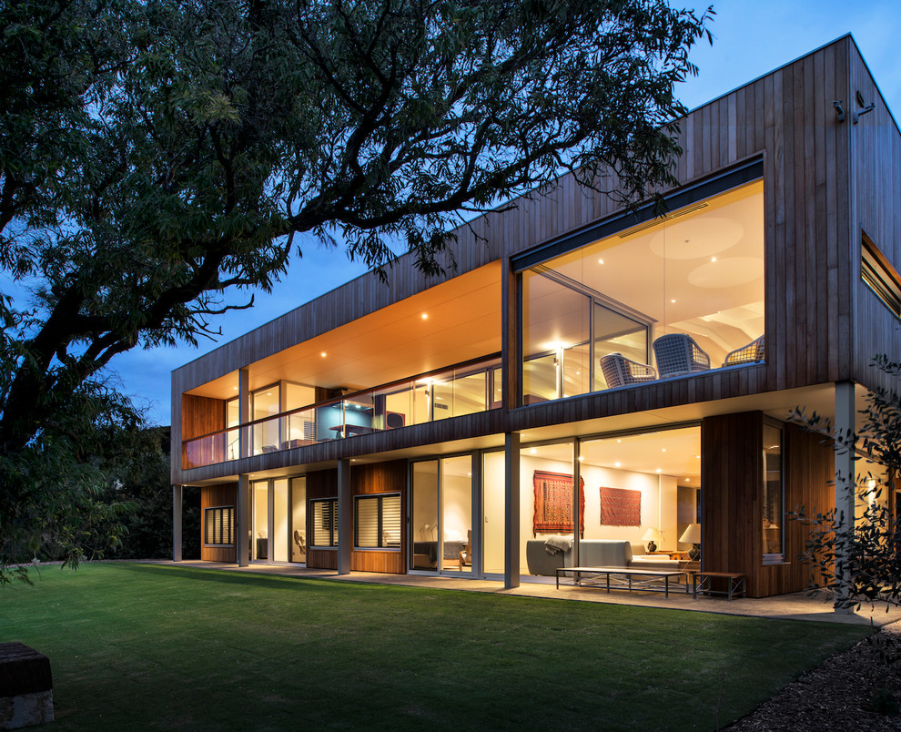 Design ideas for a large contemporary two-storey exterior in Perth with wood siding and a flat roof.