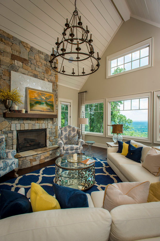 Inspiration for a mid-sized arts and crafts family room in Other with beige walls, dark hardwood floors, a standard fireplace, a stone fireplace surround and a concealed tv.