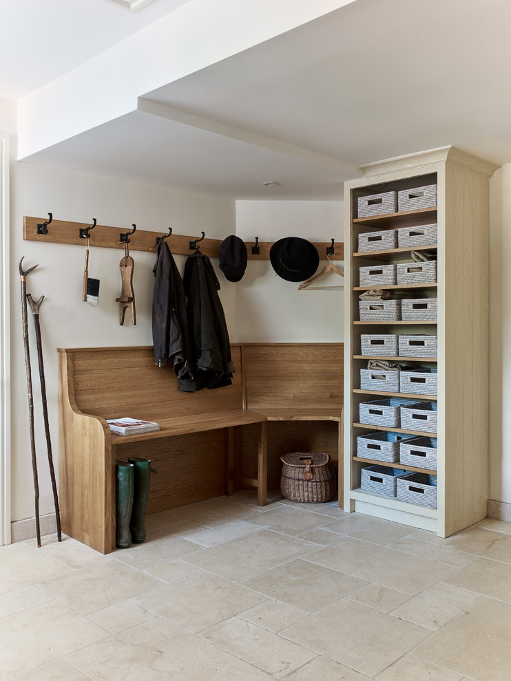 Mid-sized traditional mudroom in Berkshire with white walls, travertine floors and beige floor.