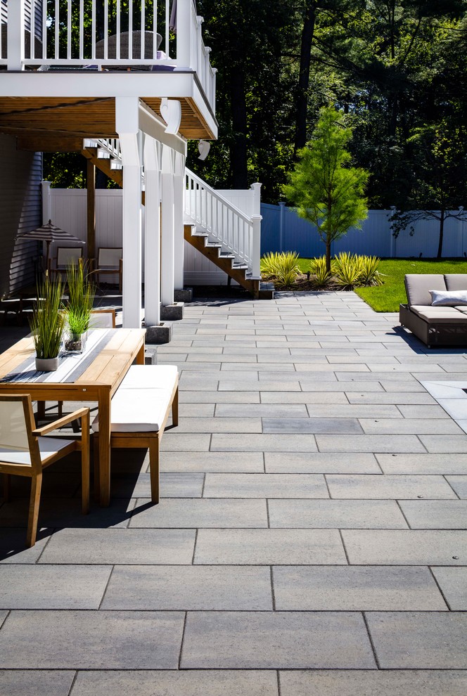 This is an example of a large contemporary patio in Other with concrete pavers.