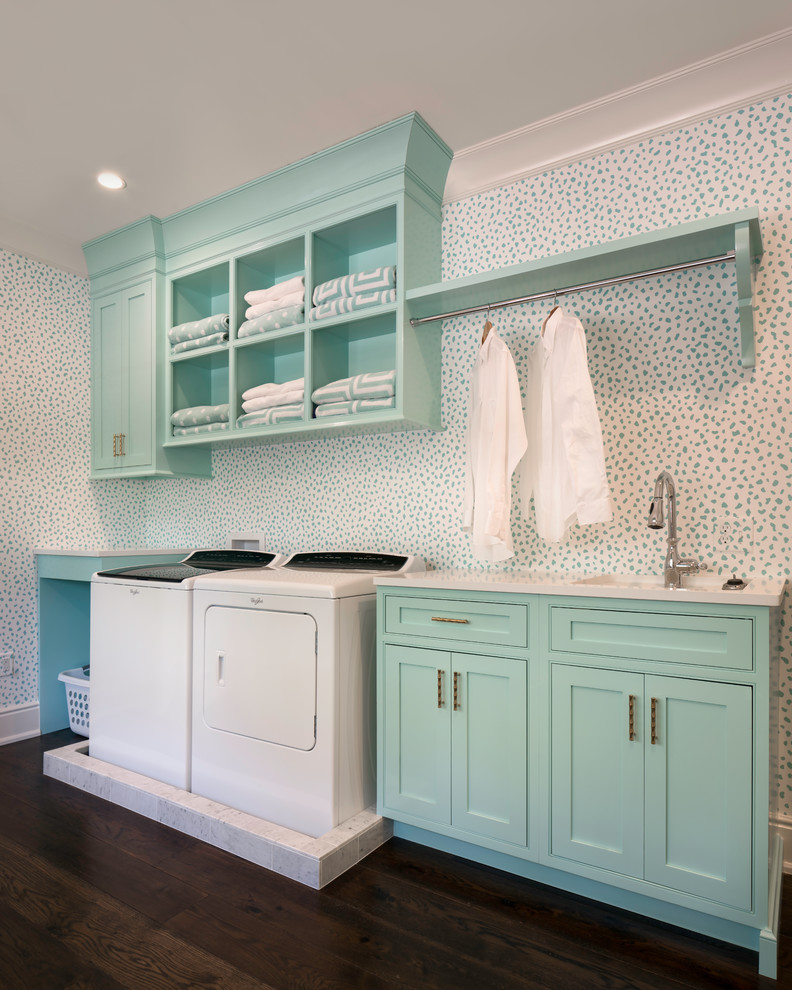 Design ideas for a beach style single-wall dedicated laundry room with an undermount sink, white walls, dark hardwood floors, a side-by-side washer and dryer, brown floor, white benchtop, beaded inset cabinets and blue cabinets.