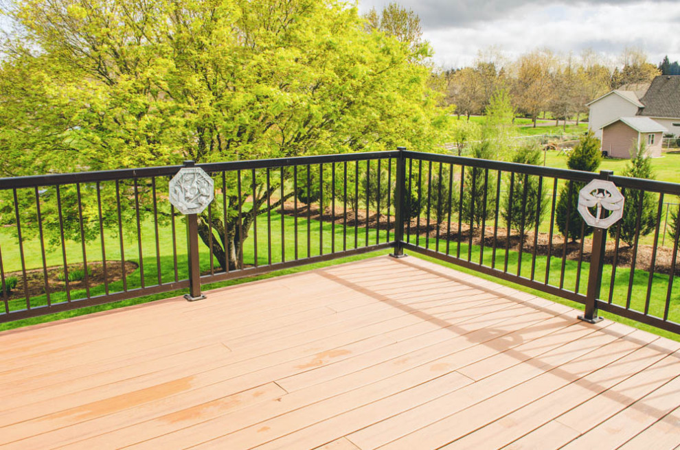 Example of a huge transitional backyard second story metal railing deck design in Portland