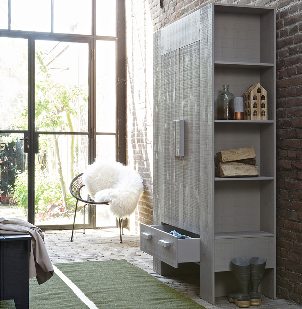 Inspiration for a scandinavian storage and wardrobe in Dorset with brick floors.