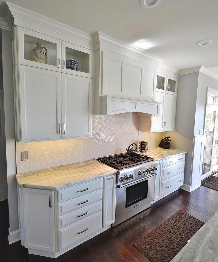 Example of a huge transitional l-shaped dark wood floor and brown floor eat-in kitchen design in Philadelphia with an undermount sink, raised-panel cabinets, white cabinets, granite countertops, white backsplash, subway tile backsplash, paneled appliances and an island