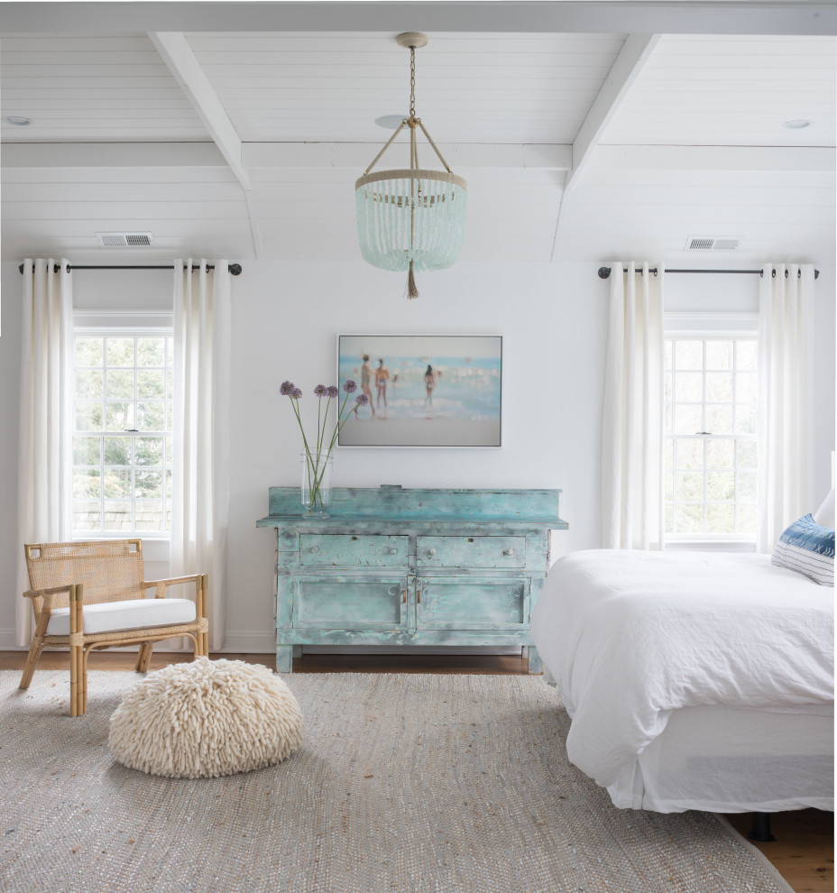 Cette photo montre une grande chambre parentale bord de mer avec un mur blanc, parquet clair, un sol marron et un plafond en lambris de bois.