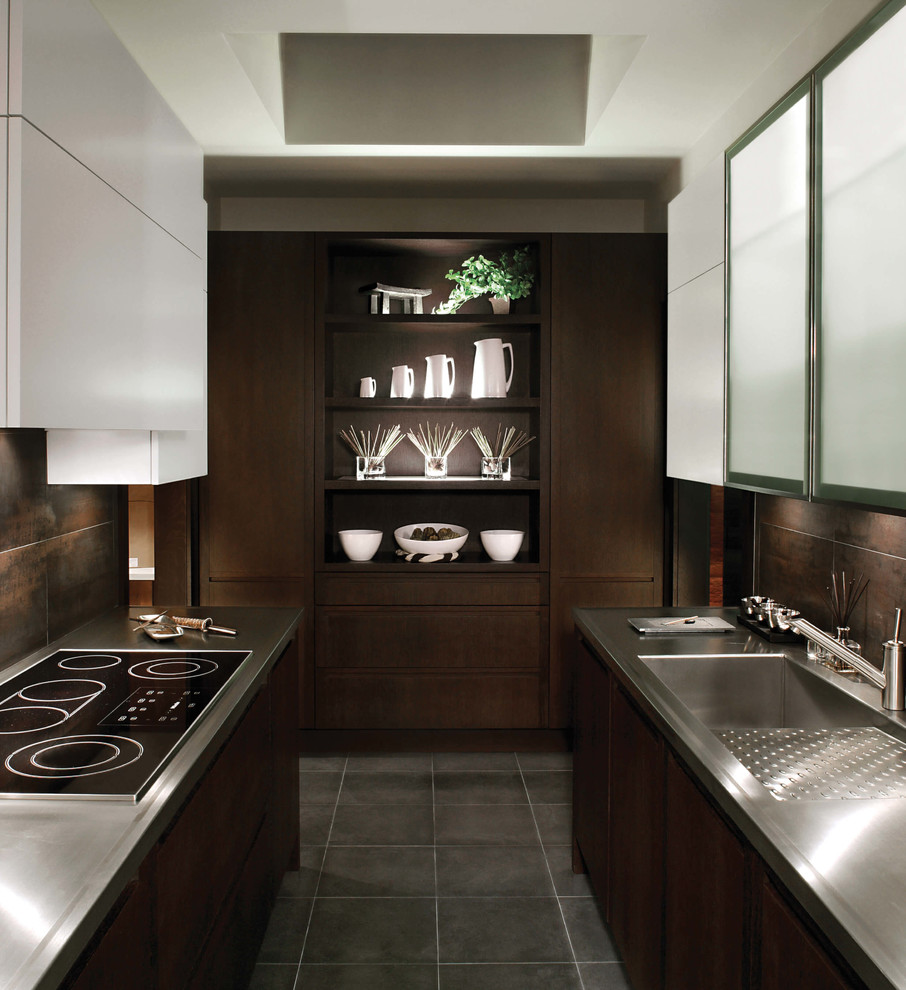 Photo of a mid-sized contemporary galley eat-in kitchen in Miami with an integrated sink, flat-panel cabinets, dark wood cabinets, stainless steel benchtops, metallic splashback, stone tile splashback, panelled appliances and limestone floors.